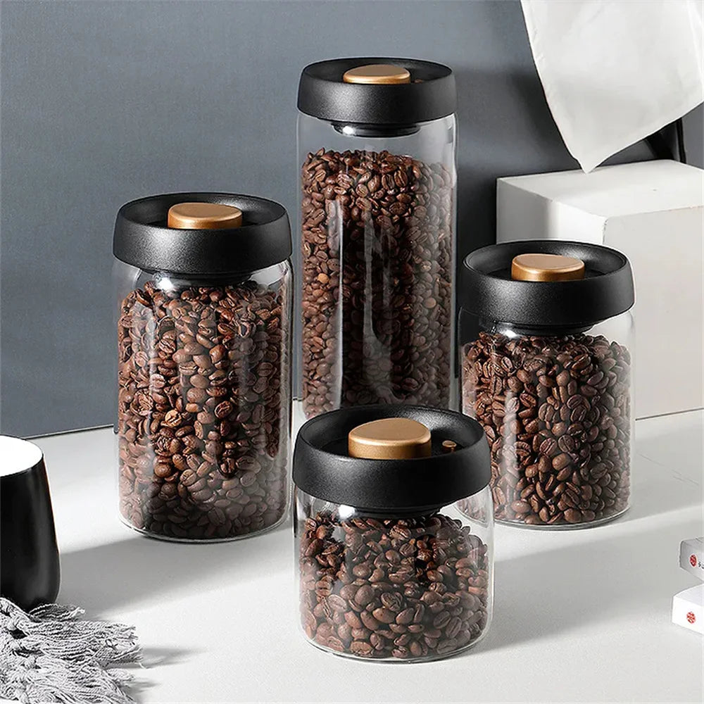 Vacuum-seal glass coffee canister with wood-grain lid on a kitchen counter