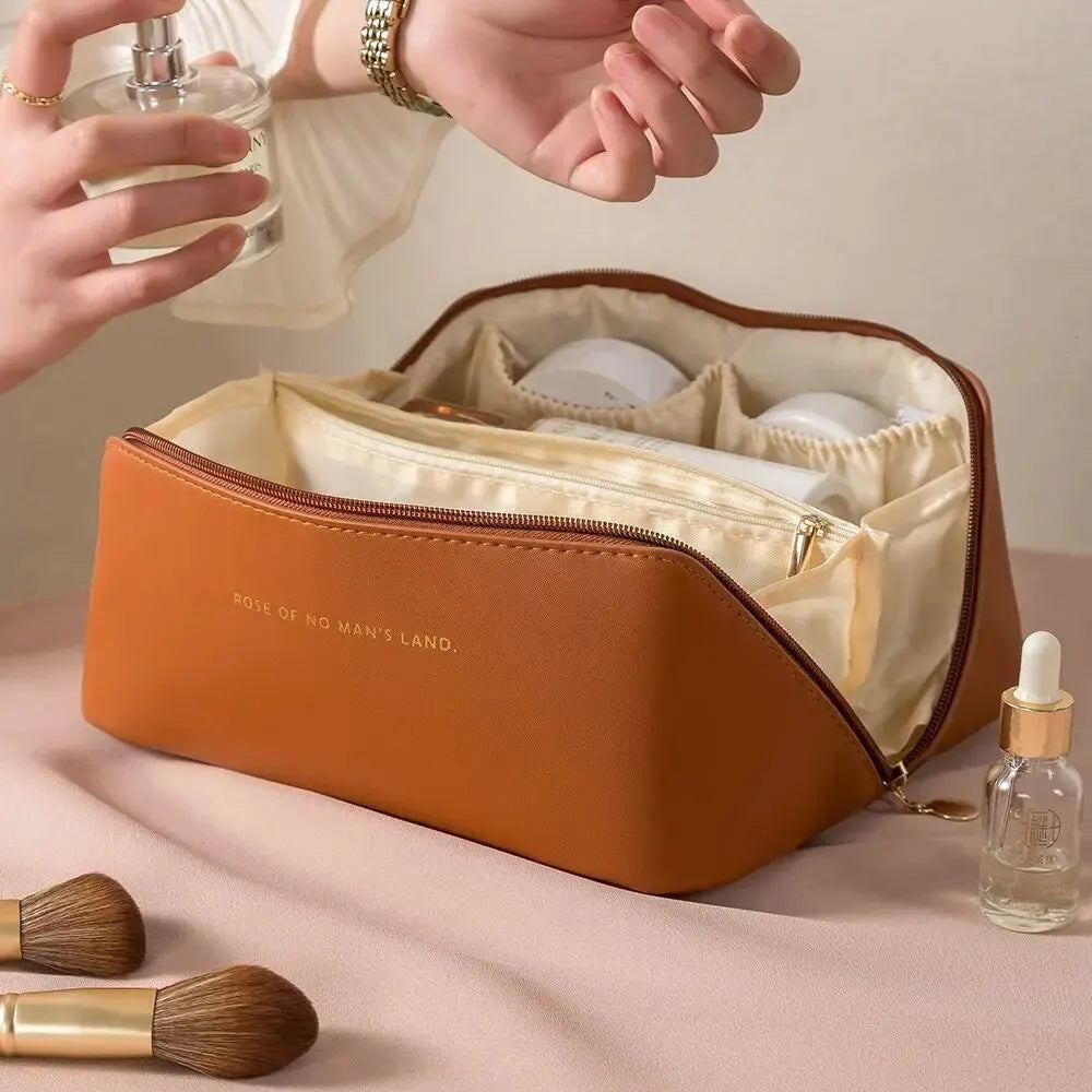 Travel toiletry bag folded closed and packed in a suitcase