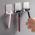 Stainless steel self-adhesive razor holder mounted on a shower wall