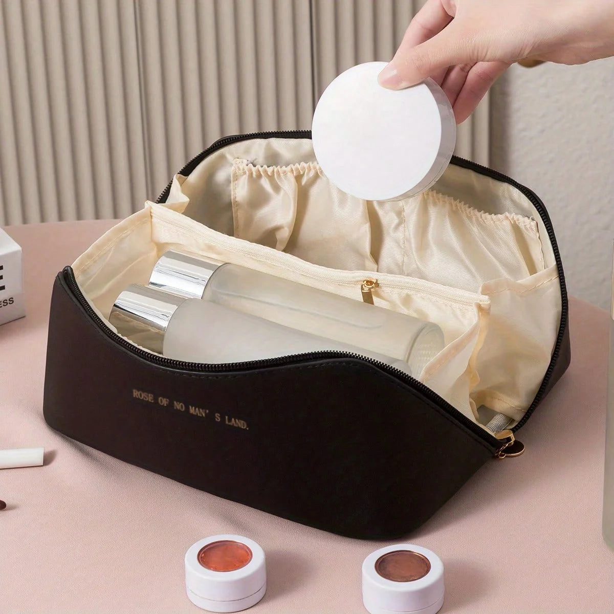 Travel toiletry bag open showing multiple interior compartments